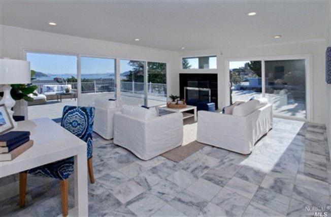 49 Reed Ranch Road Tiburon, CA 94920 - Photo 1 of 1 a living room with furniture a fireplace and a table