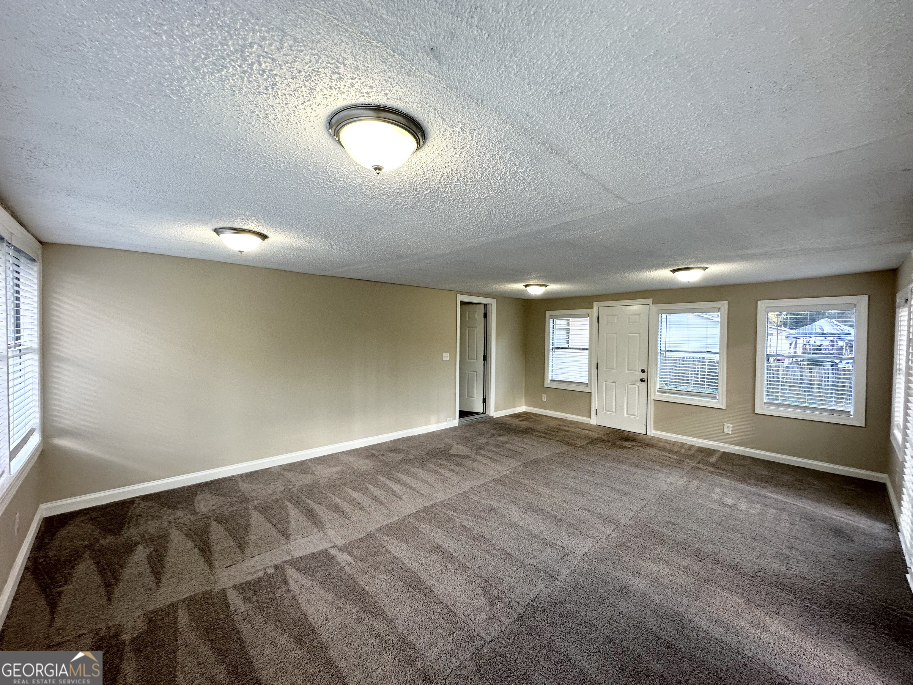 7125 Rhodes Street Lithonia, GA 30058 - Photo 11 of 30 an empty room with windows
