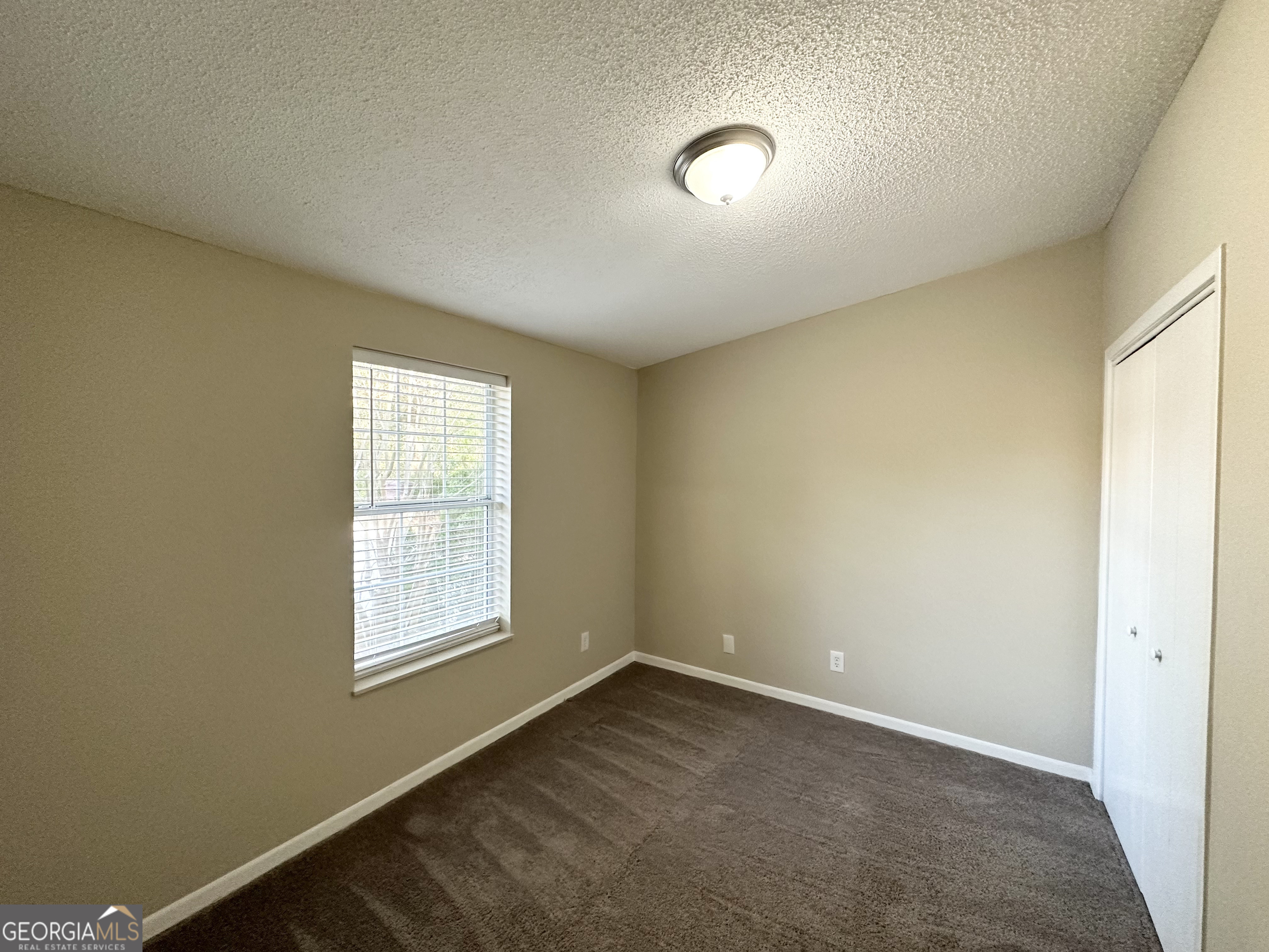7125 Rhodes Street Lithonia, GA 30058 - Photo 12 of 30 an empty room with windows