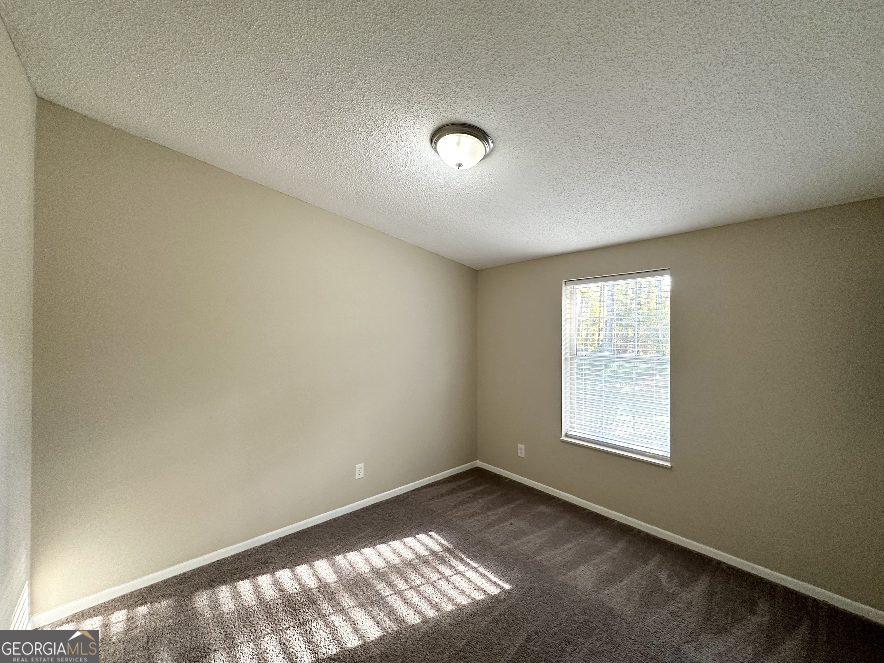 7125 Rhodes Street Lithonia, GA 30058 - Photo 16 of 30 an empty room with windows