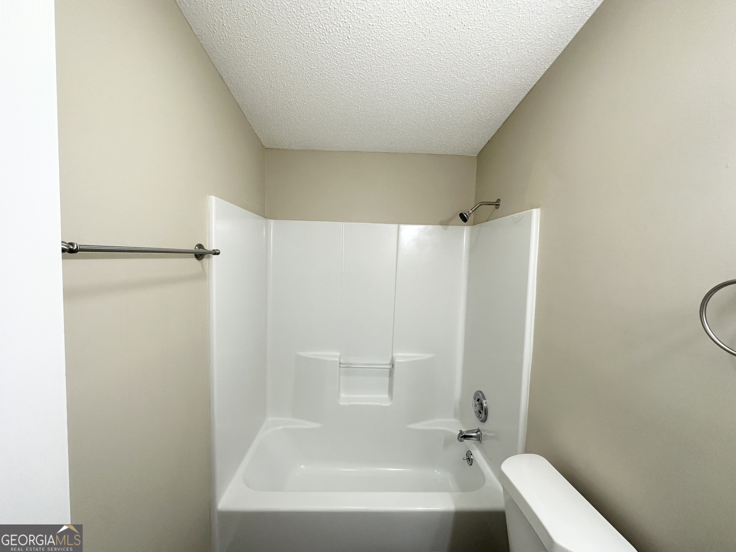 7125 Rhodes Street Lithonia, GA 30058 - Photo 20 of 30 a bathroom with a bathtub and a shower