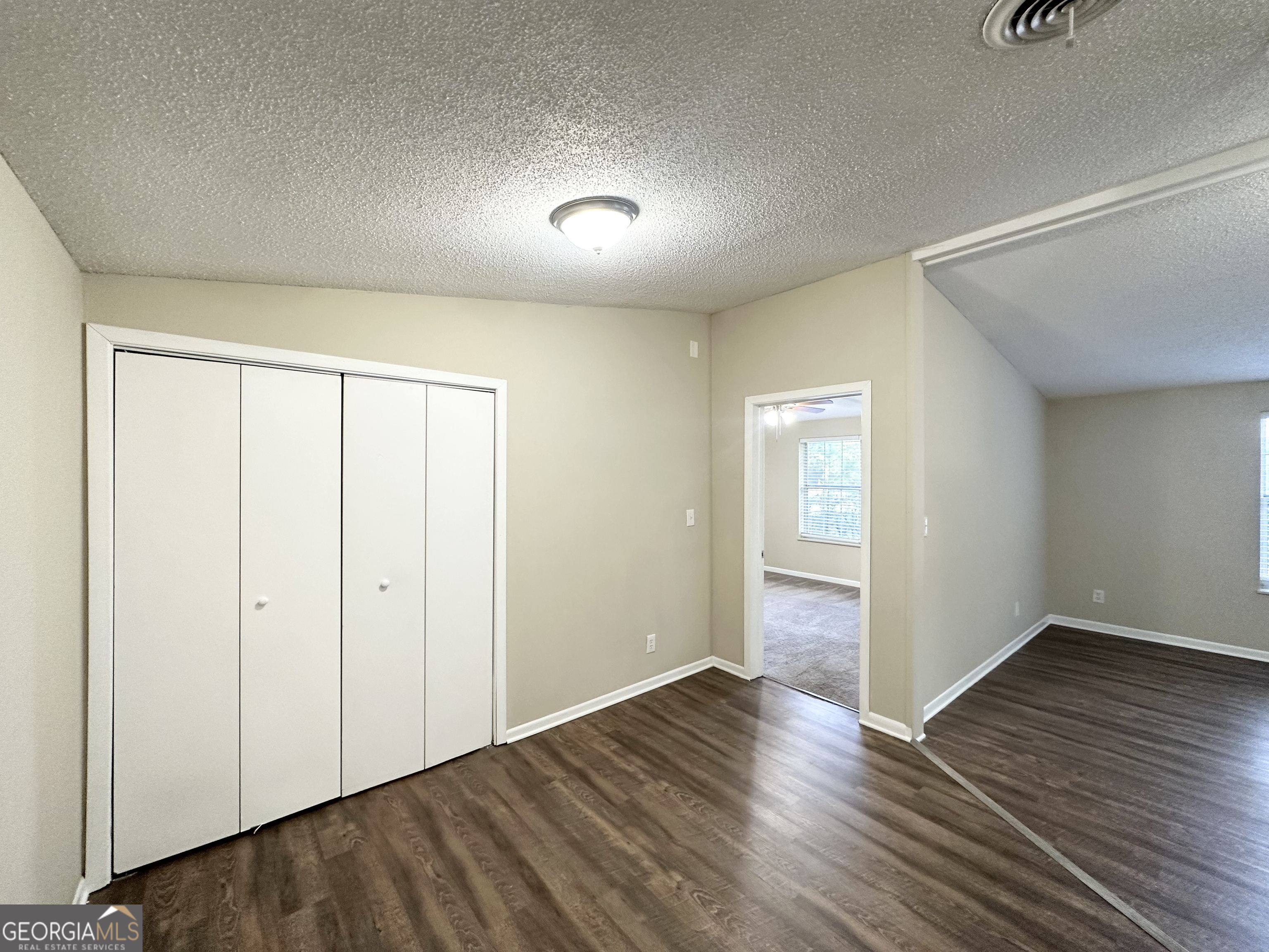 7125 Rhodes Street Lithonia, GA 30058 - Photo 22 of 30 an empty room with wooden floor & closet area
