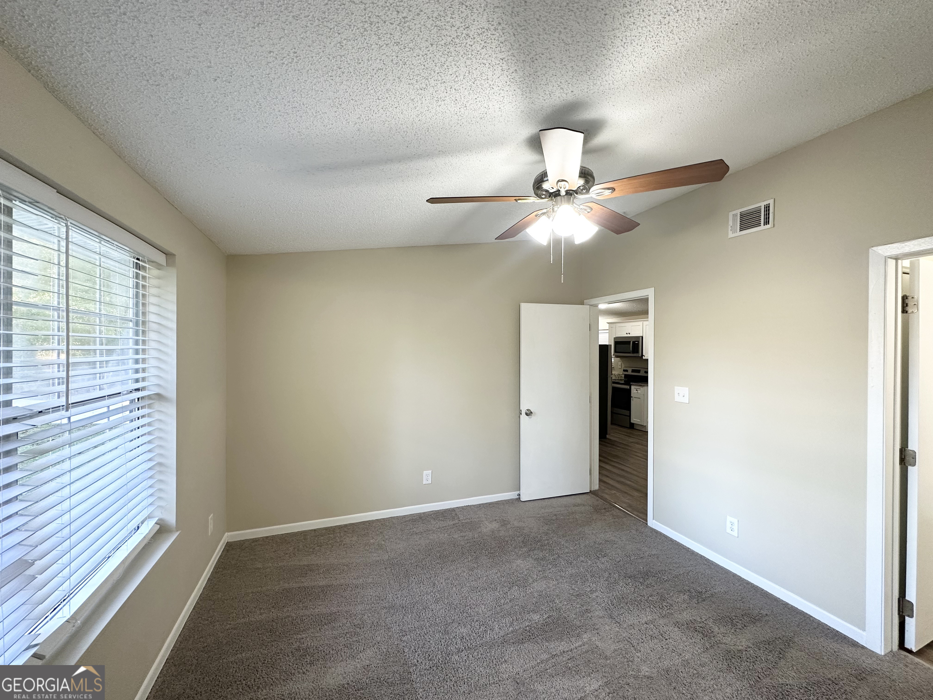 7125 Rhodes Street Lithonia, GA 30058 - Photo 25 of 30 an empty room with fan and windows