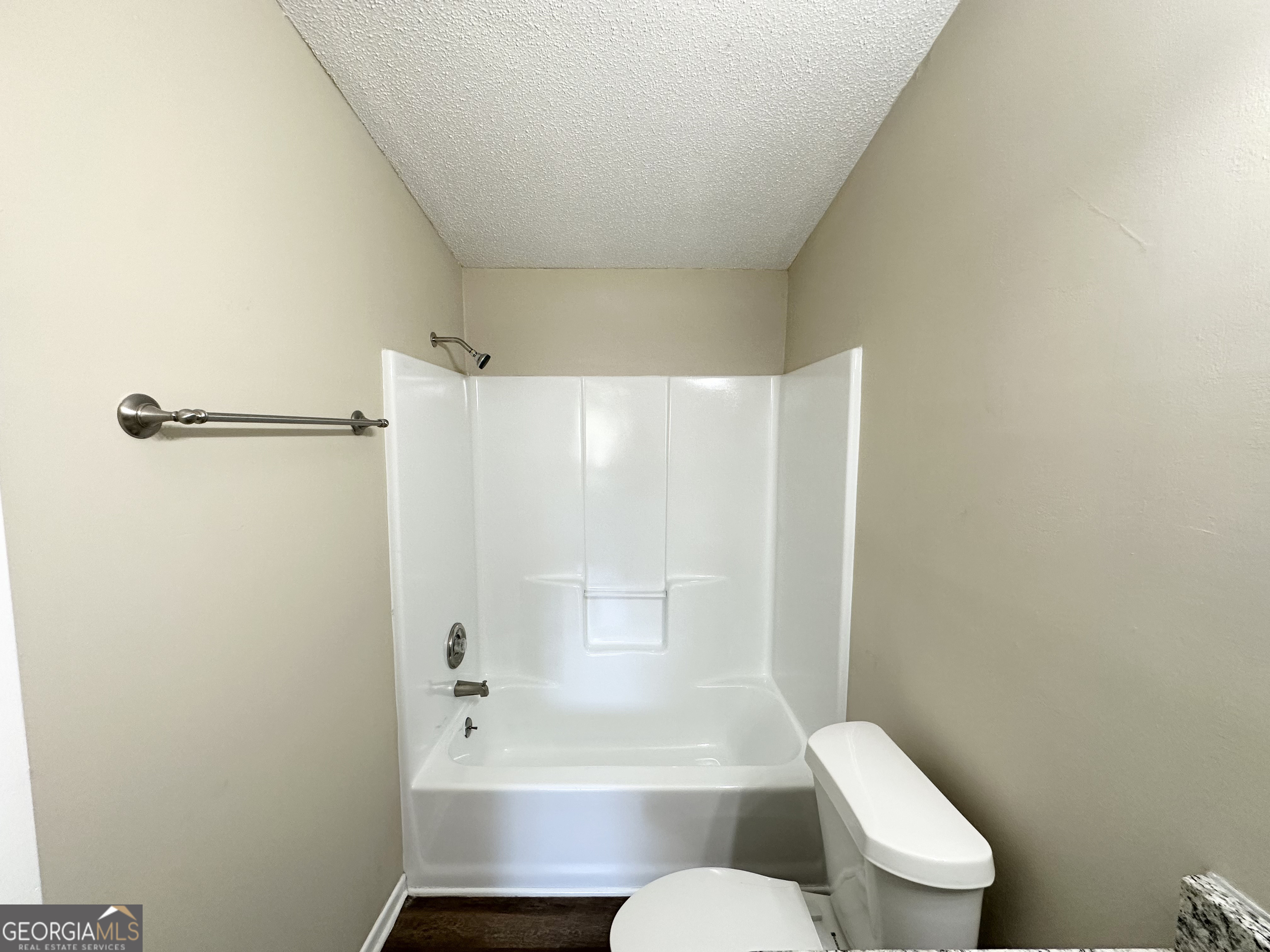 7125 Rhodes Street Lithonia, GA 30058 - Photo 27 of 30 a bathroom with a toilet and a bathtub