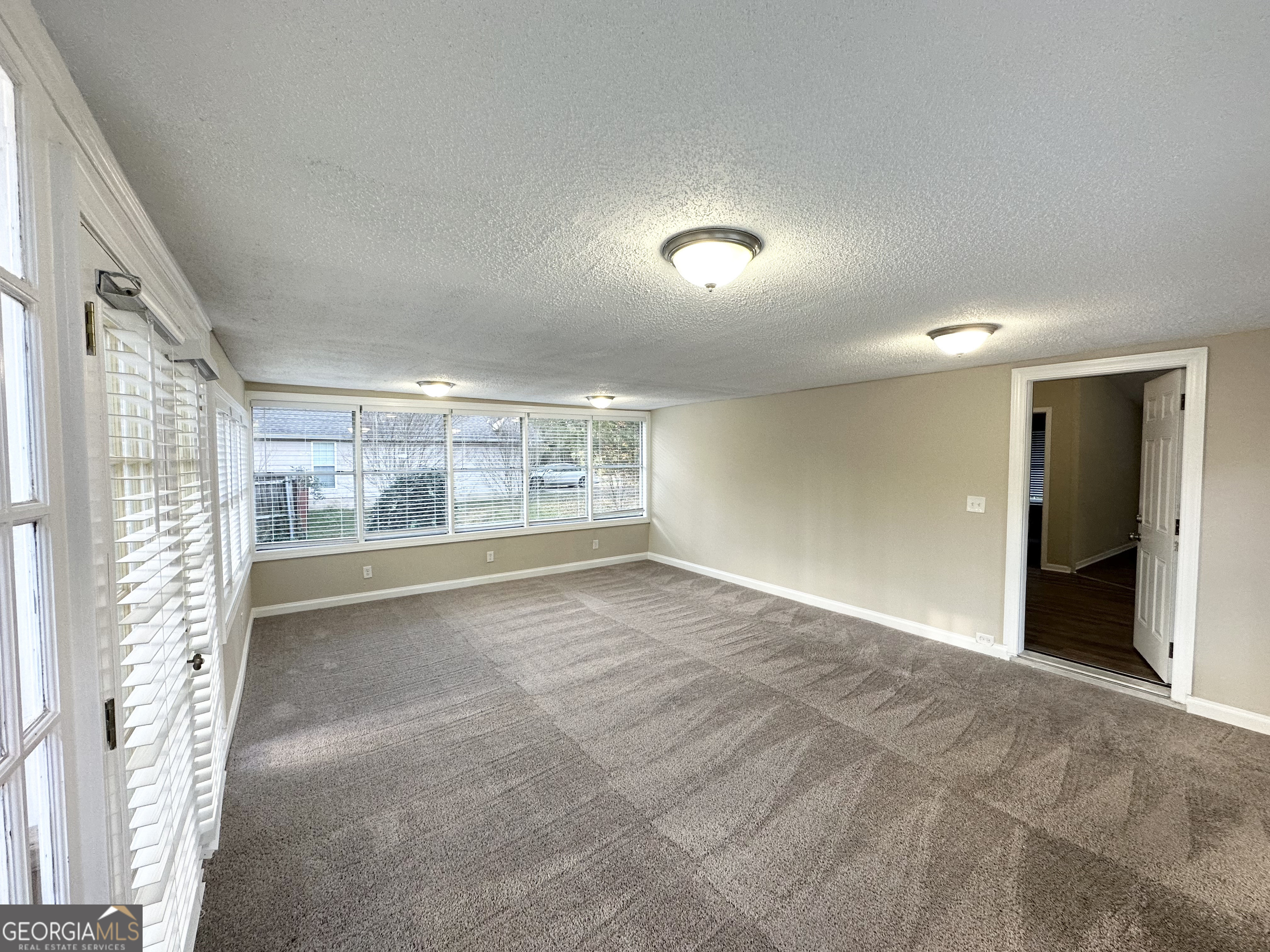 7125 Rhodes Street Lithonia, GA 30058 - Photo 10 of 30 a view of an empty room with a window
