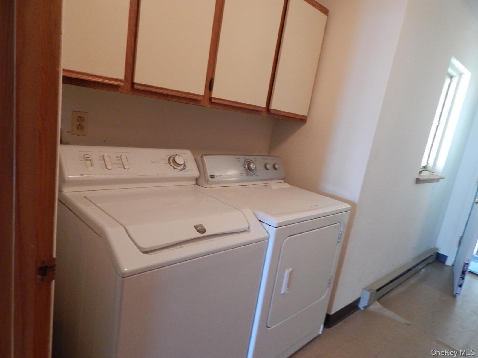 5 Eagle Head Road Cornwall-on-Hudson, NY 12520 - Photo 11 of 24 Laundry area featuring washing machine and dryer, cabinet space, and baseboard heating