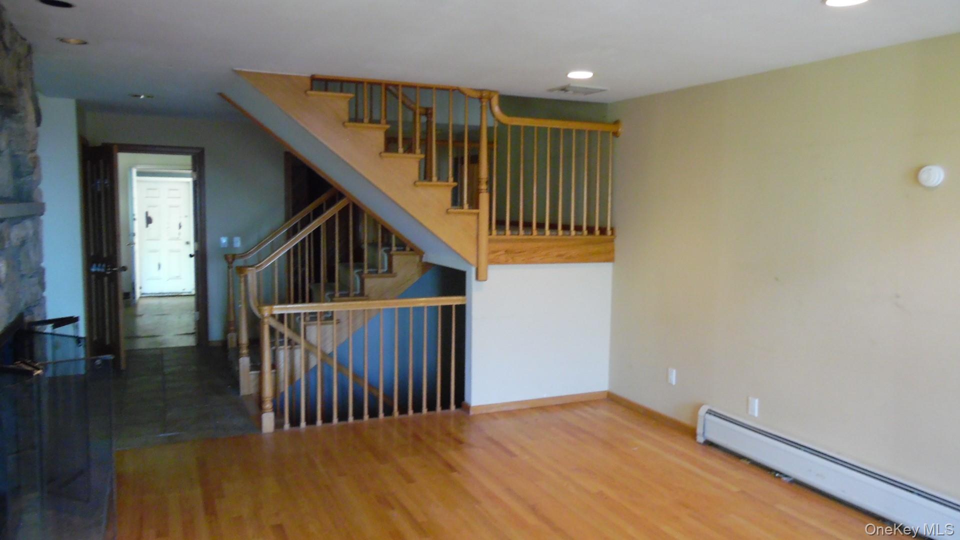 5 Eagle Head Road Cornwall-on-Hudson, NY 12520 - Photo 12 of 24 Staircase with a baseboard heating unit, wood finished floors, and recessed lighting
