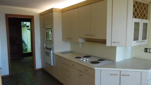 a kitchen with a stove and a cabinets