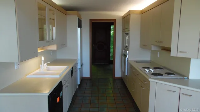 a kitchen with stainless steel appliances a sink stove and cabinets