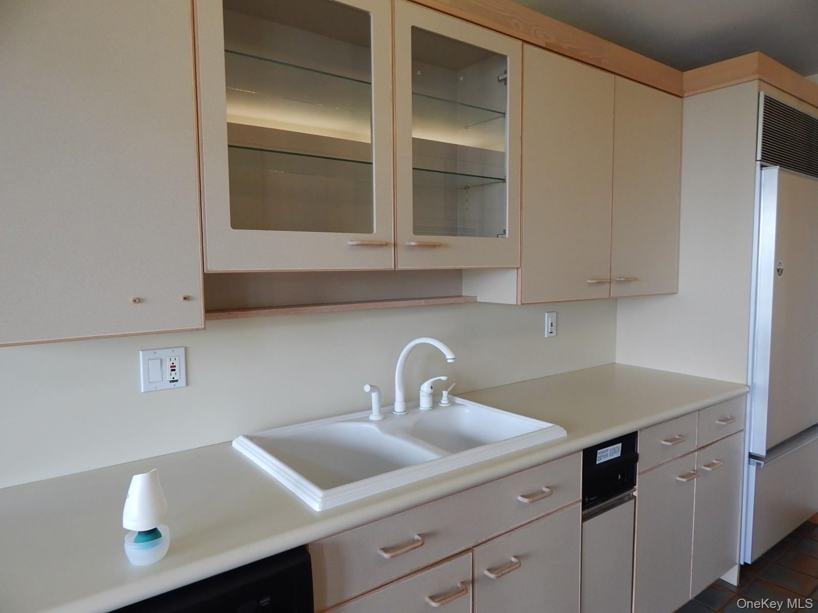 5 Eagle Head Road Cornwall-on-Hudson, NY 12520 - Photo 5 of 24 Kitchen featuring glass fronted cabinets, light countertops, freestanding refrigerator, and cream cabinets