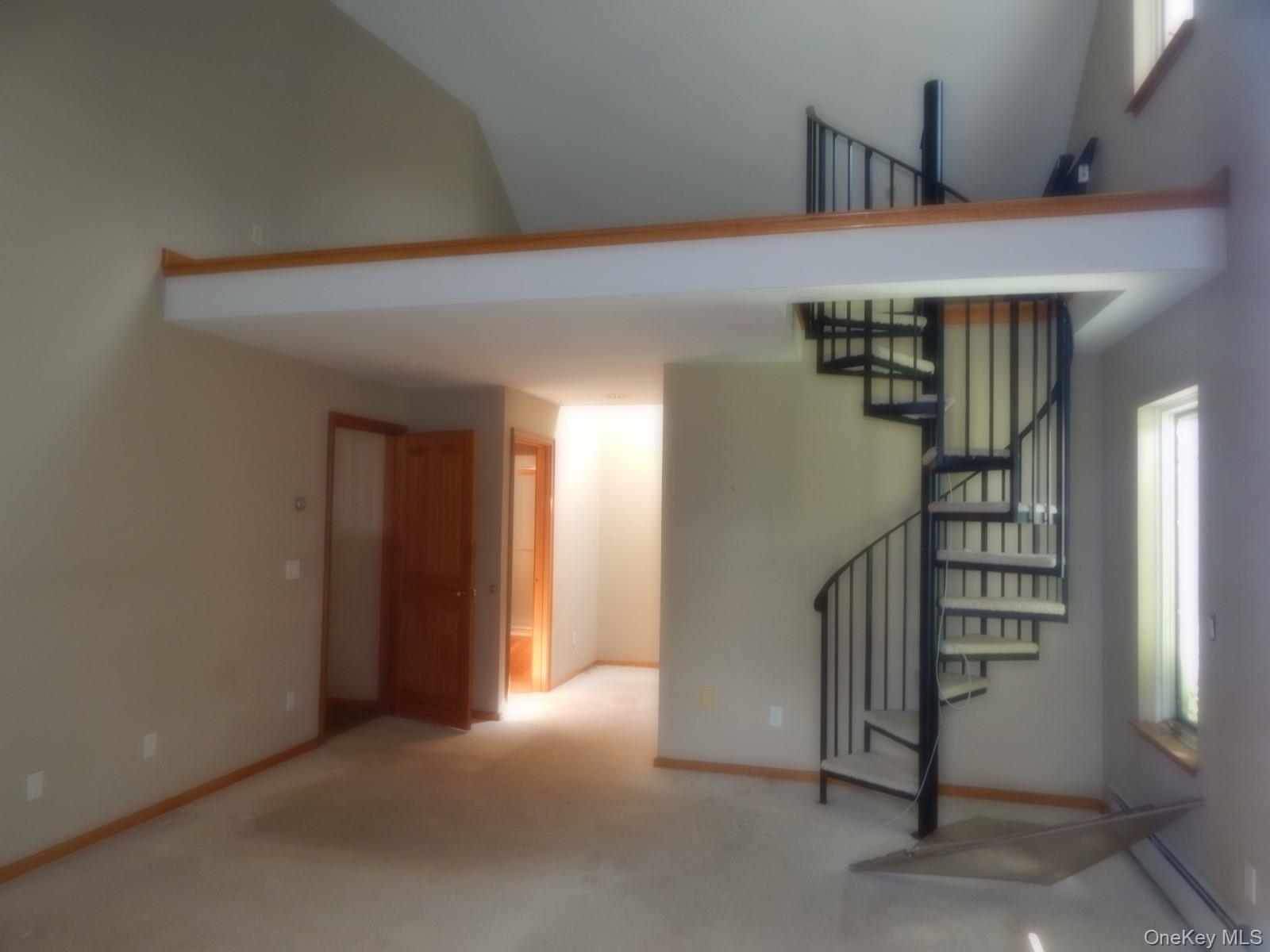 5 Eagle Head Road Cornwall-on-Hudson, NY 12520 - Photo 8 of 24 First floor bedroom with spiral staircase to upper loft with carpet and a high ceiling
