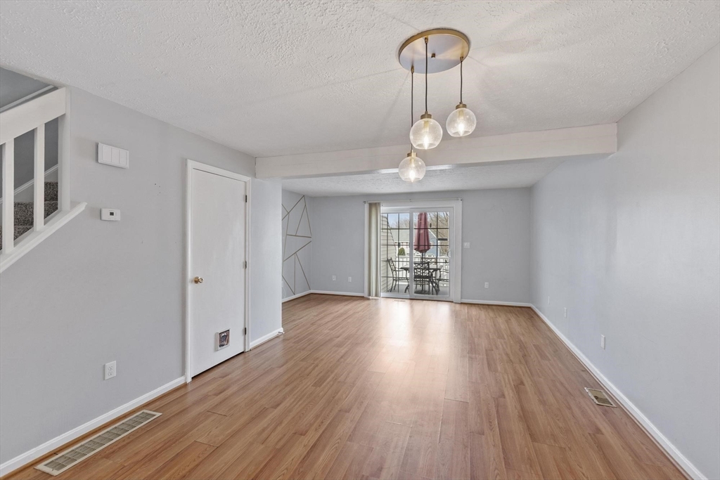 48 Fox Meadow Road, Unit F Leominster, MA 01453 - Photo 11 of 36 wooden floor in an empty room with a window