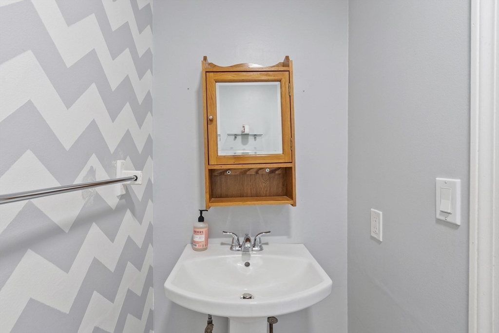48 Fox Meadow Road, Unit F Leominster, MA 01453 - Photo 12 of 36 a bathroom with a sink and a mirror