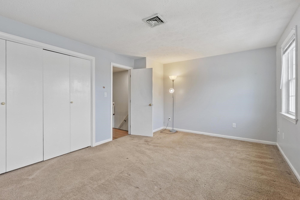 48 Fox Meadow Road, Unit F Leominster, MA 01453 - Photo 13 of 36 a view of an empty room with window and closet area