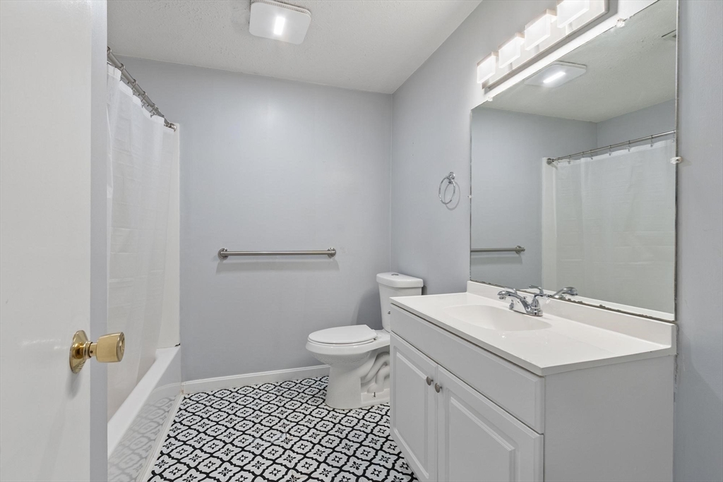 48 Fox Meadow Road, Unit F Leominster, MA 01453 - Photo 16 of 36 a bathroom with a sink a toilet and shower