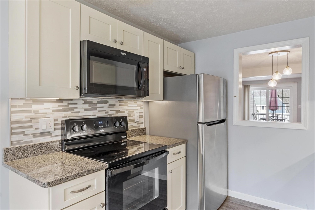 48 Fox Meadow Road, Unit F Leominster, MA 01453 - Photo 4 of 36 a kitchen with a stove microwave and refrigerator