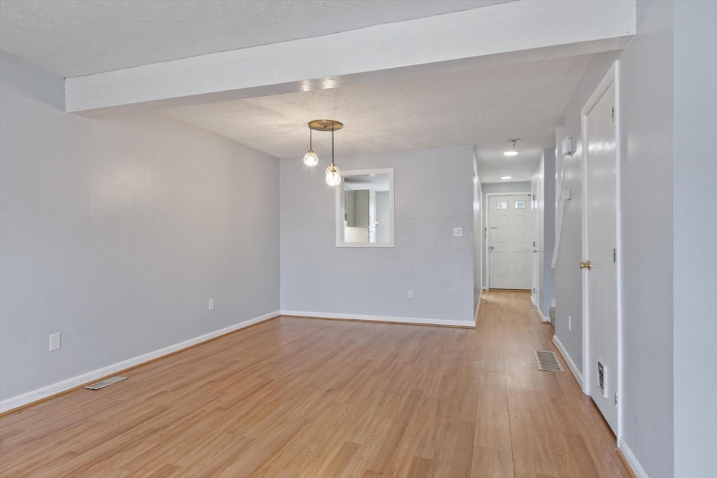48 Fox Meadow Road, Unit F Leominster, MA 01453 - Photo 9 of 36 wooden floor in an empty room with a window
