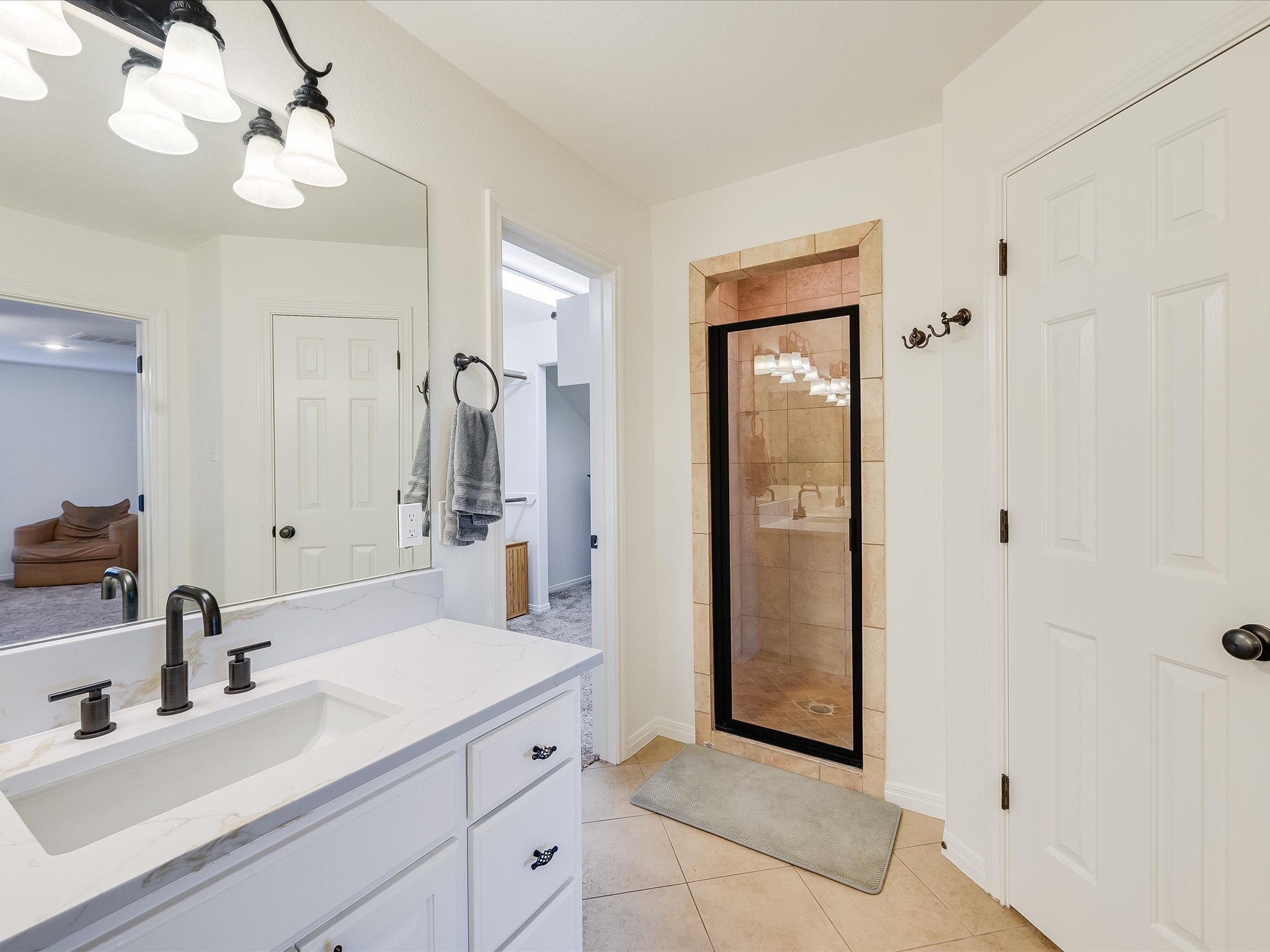 15214 Nightingale Lane Austin, TX 78734 - Photo 16 of 28 a bathroom with a sink a light fixture and a mirror