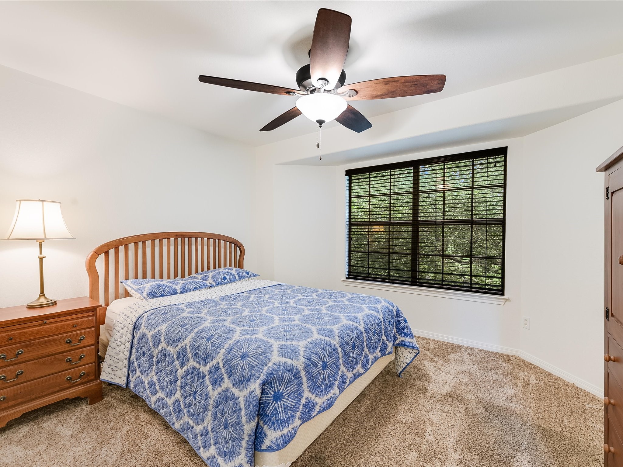 15214 Nightingale Lane Austin, TX 78734 - Photo 17 of 28 a bedroom with a large bed and a window