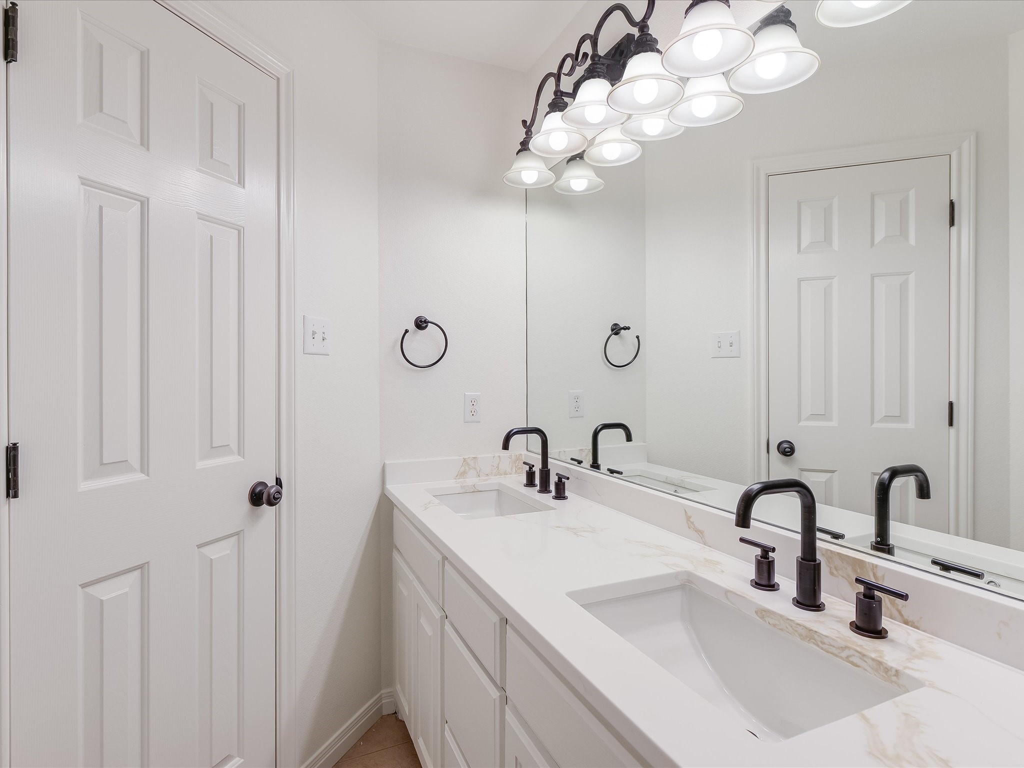 15214 Nightingale Lane Austin, TX 78734 - Photo 19 of 28 a bathroom with 2 sink and a mirror