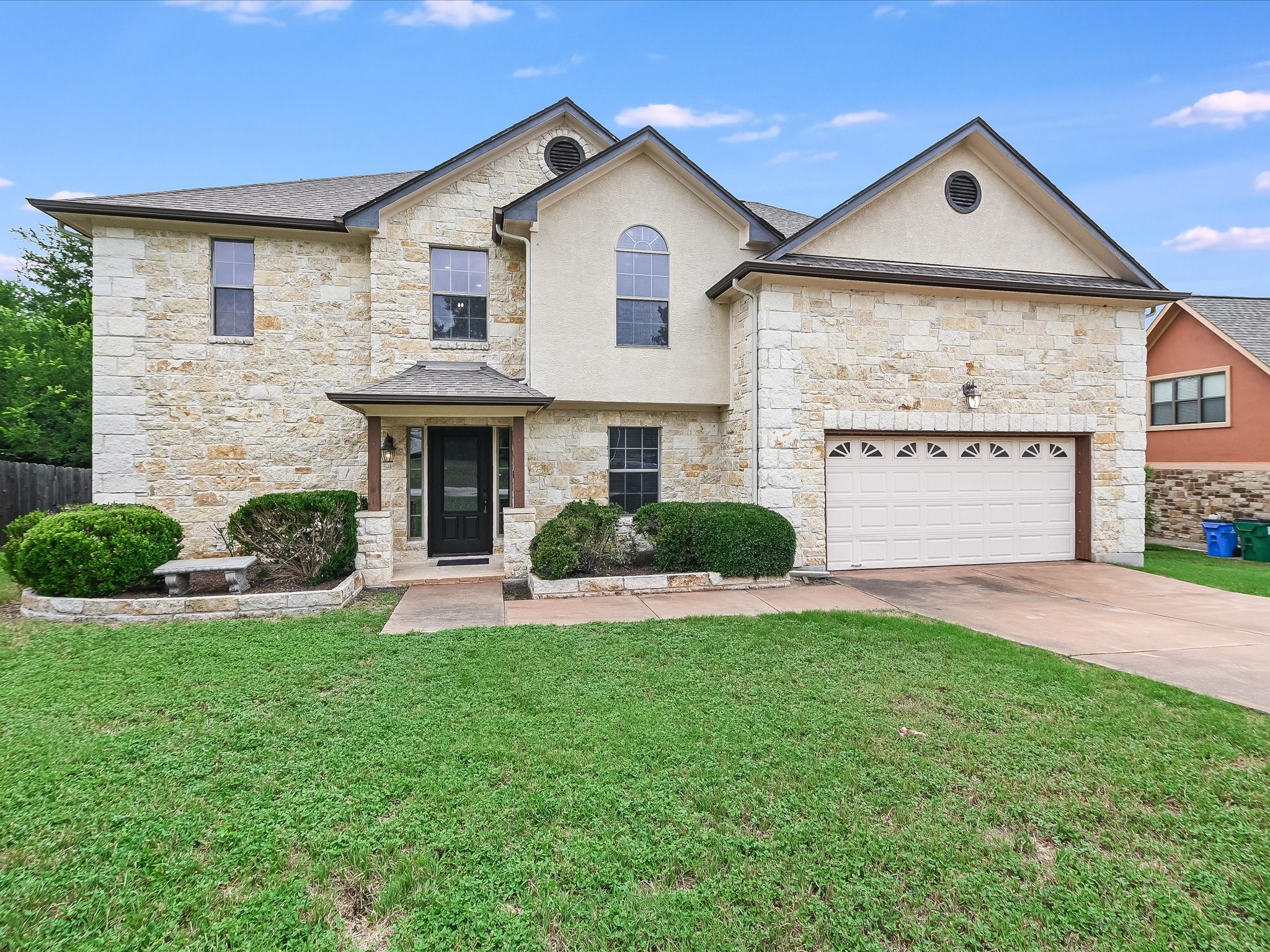 15214 Nightingale Lane Austin, TX 78734 - Photo 2 of 28 a front view of a house with a yard and garage