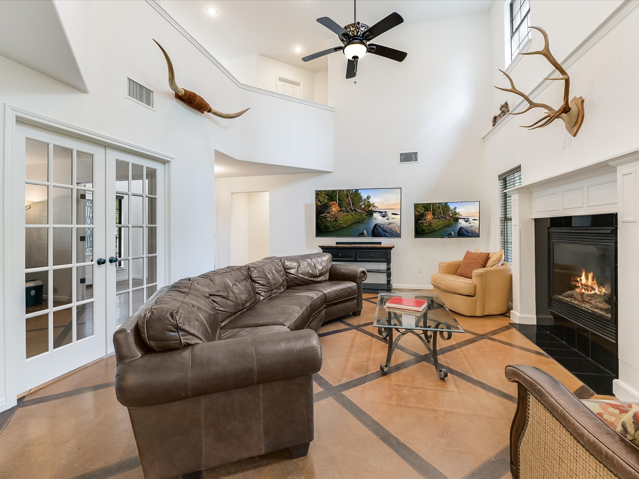15214 Nightingale Lane Austin, TX 78734 - Photo 4 of 28 a living room with furniture a fireplace and a flat screen tv