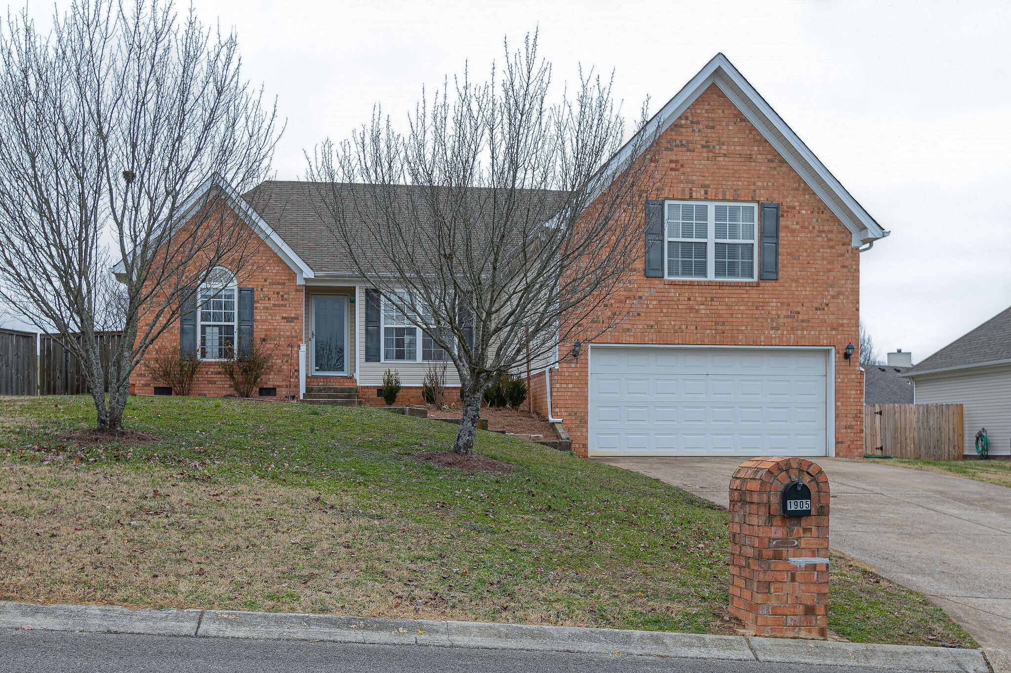 1905 Portway Road Spring Hill, TN 37174 - Photo 1 of 28 a view of a yard in front of a house with large trees