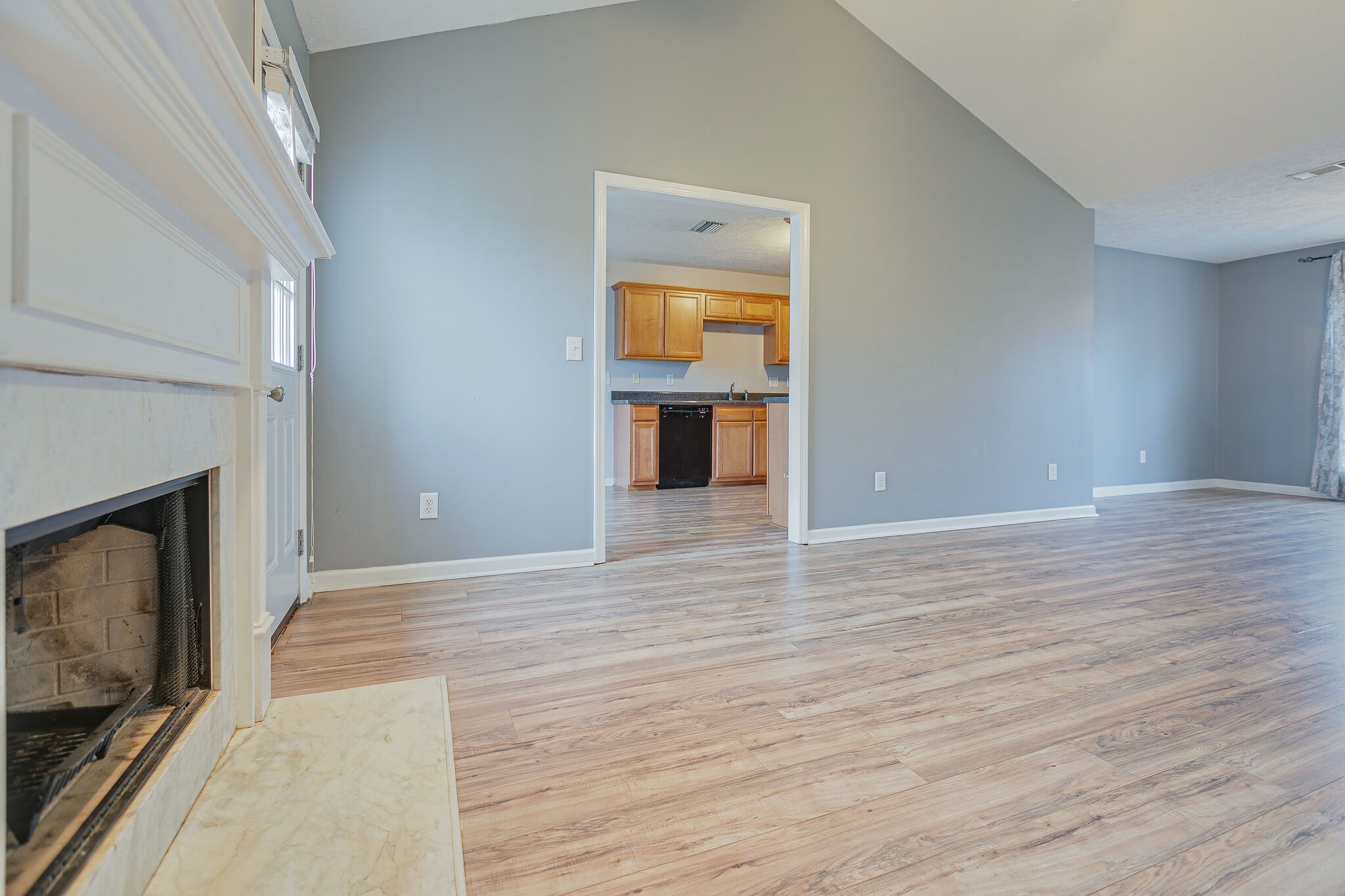 1905 Portway Road Spring Hill, TN 37174 - Photo 14 of 28 a view of an empty room with wooden floor fireplace and a window