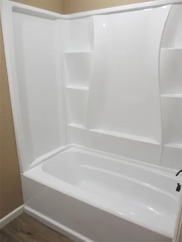 a close up of a bathtub with shower