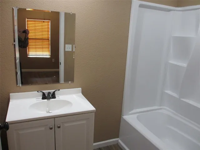 a bathroom with a sink and a bathtub