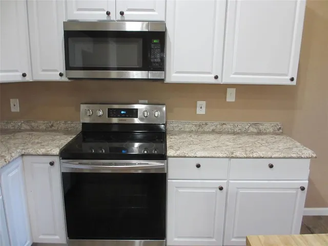 a stove top oven sitting inside of a kitchen