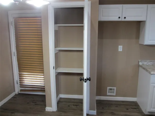 a view of walk in closet with empty racks