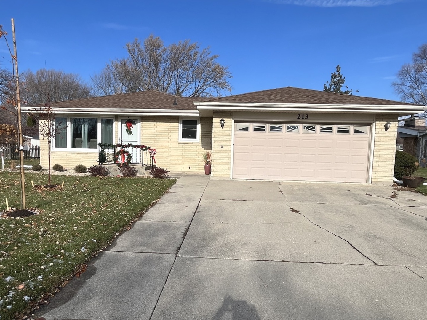 213 School Avenue Rochelle, IL 61068 - Photo 1 of 26 a front view of a house with a garden and trees