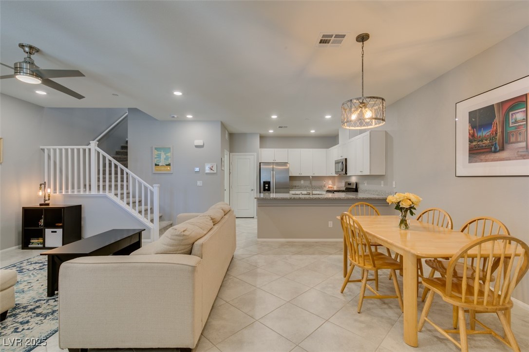 2870 Turnstone Ridge Street Henderson, NV 89044 - Photo 4 of 50 Living room featuring stairway, a ceiling fan, recessed lighting, light tile patterned floors, and a chandelier