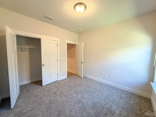 an empty room with closet area