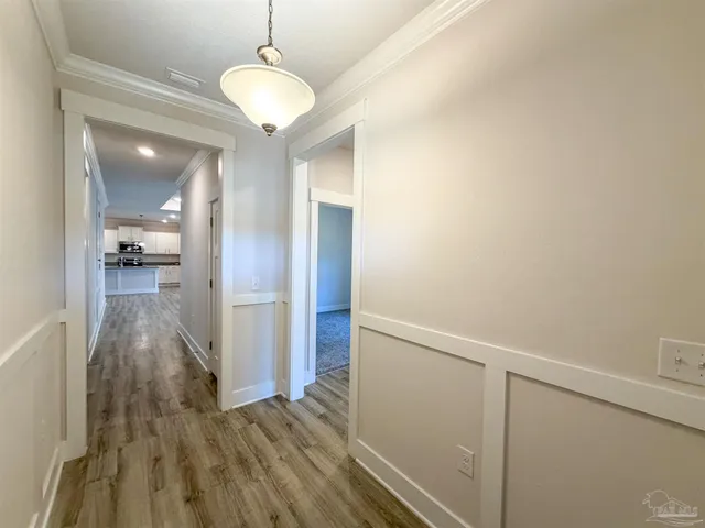 a view of a room with wooden floor