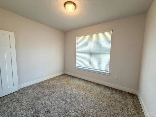 an empty room with a empty space and a window