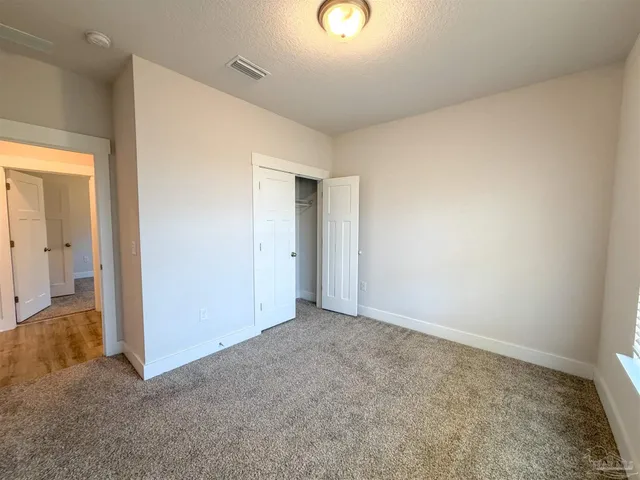 an empty room with closet area