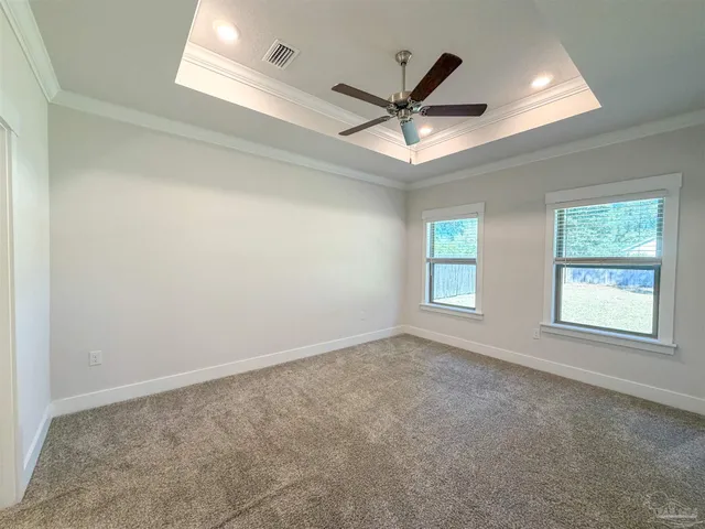 an empty room with fan and windows