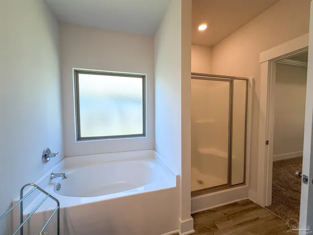 a bathroom with a tub and shower
