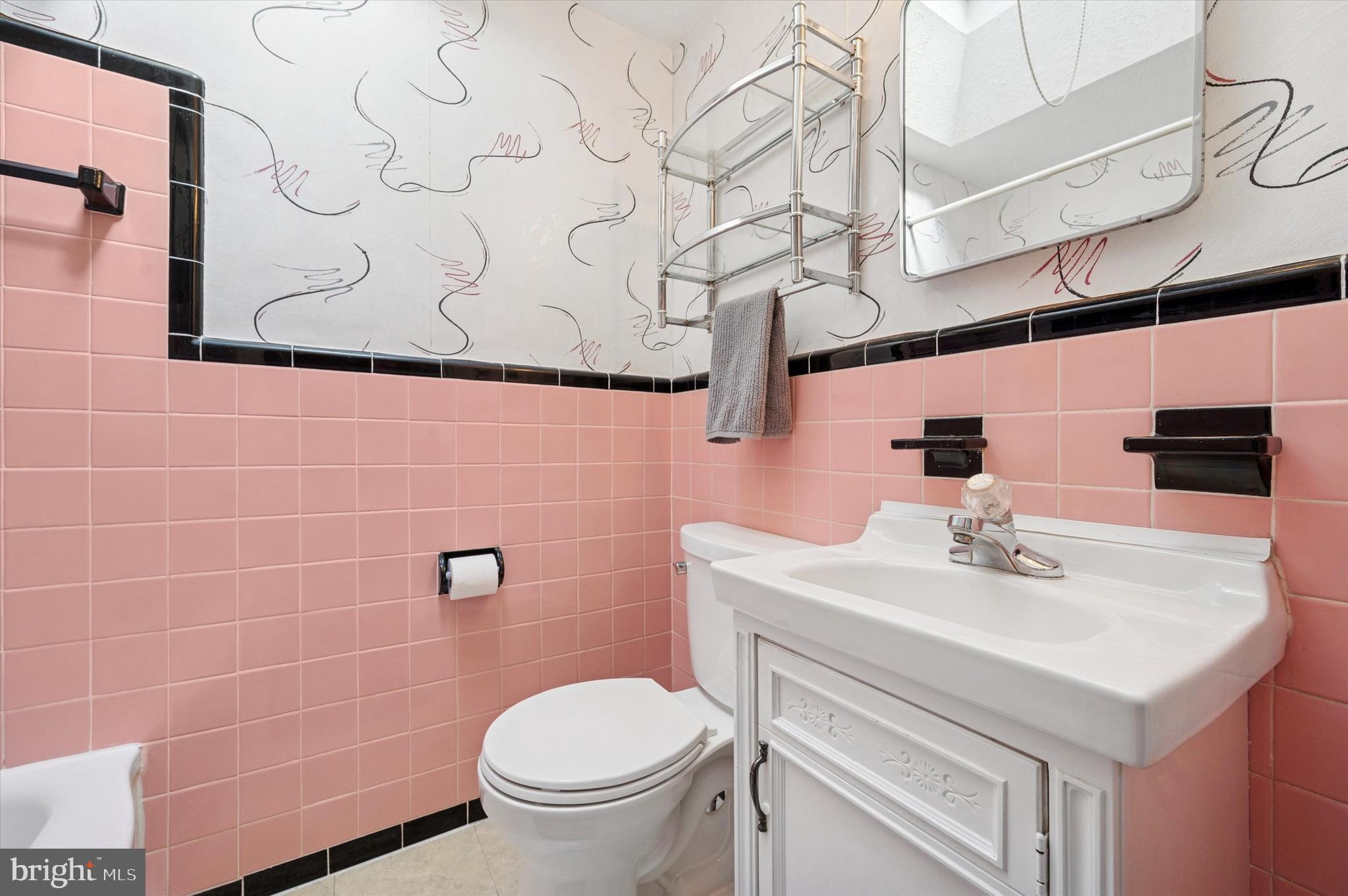 1075 Stratford Road Glenolden, PA 19036 - Photo 12 of 15 a bathroom with a sink a toilet and mirror
