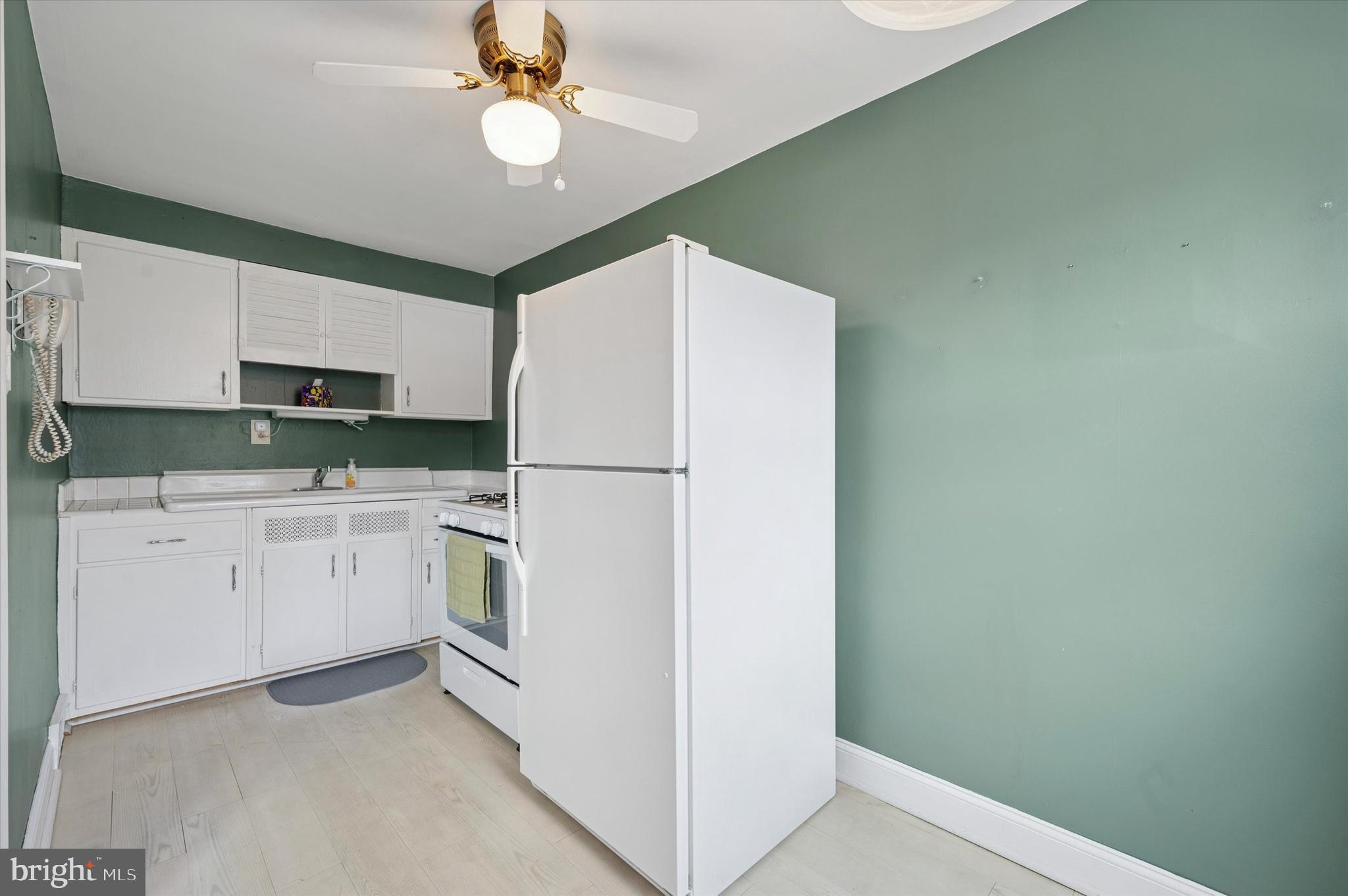 1075 Stratford Road Glenolden, PA 19036 - Photo 7 of 15 a kitchen with white cabinets and white appliances