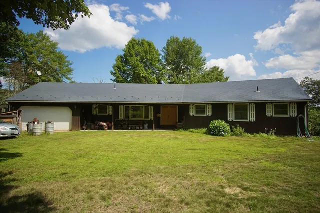 a front view of a house with yard and porch