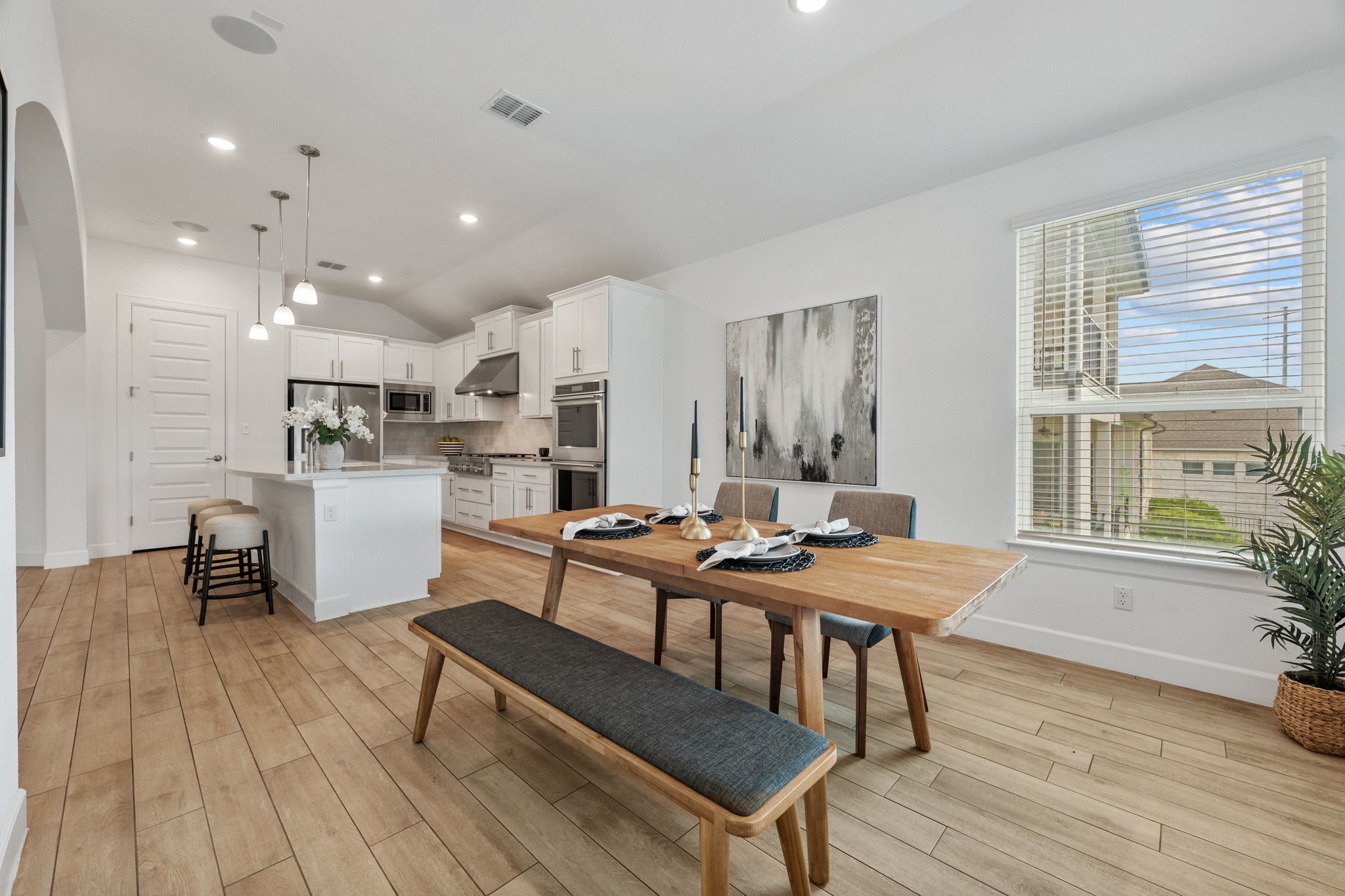 606 Bonfisk Bend Austin, TX 78738 - Photo 14 of 40 a kitchen with stainless steel appliances a dining table chairs and wooden floor