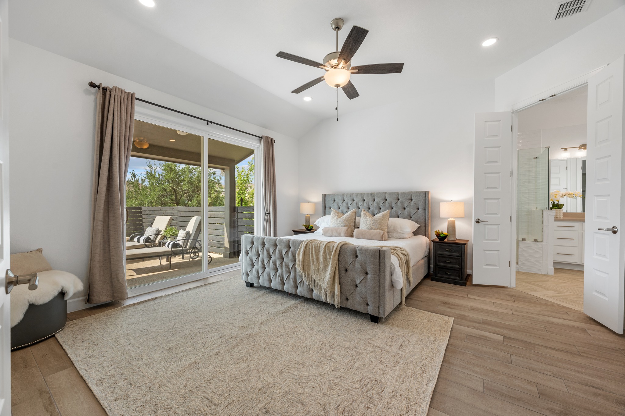 606 Bonfisk Bend Austin, TX 78738 - Photo 16 of 40 a spacious bedroom with a bed and a large window