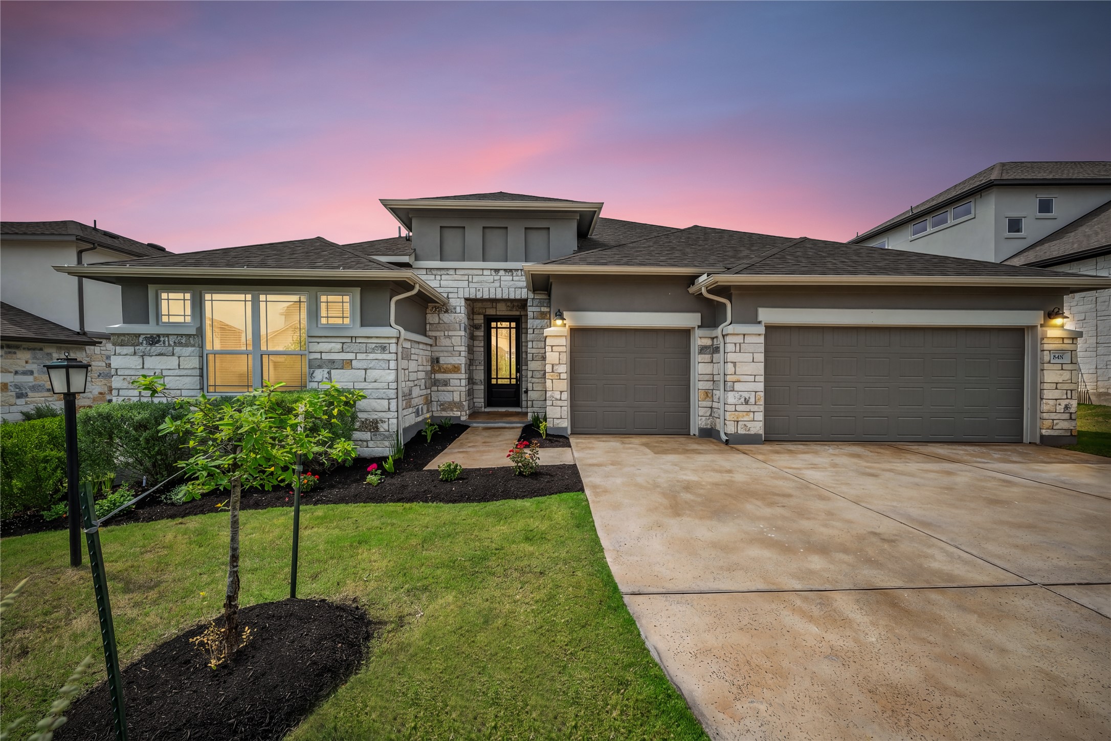 606 Bonfisk Bend Austin, TX 78738 - Photo 1 of 40 a front view of a house with a yard and garage