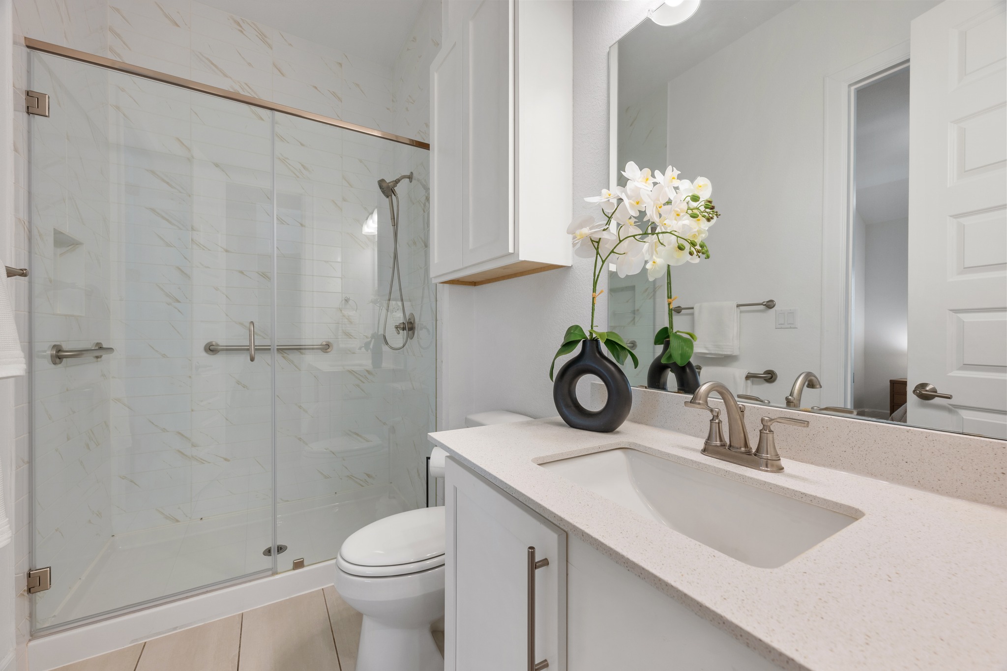 606 Bonfisk Bend Austin, TX 78738 - Photo 25 of 40 a bathroom with a granite countertop toilet a sink and a mirror