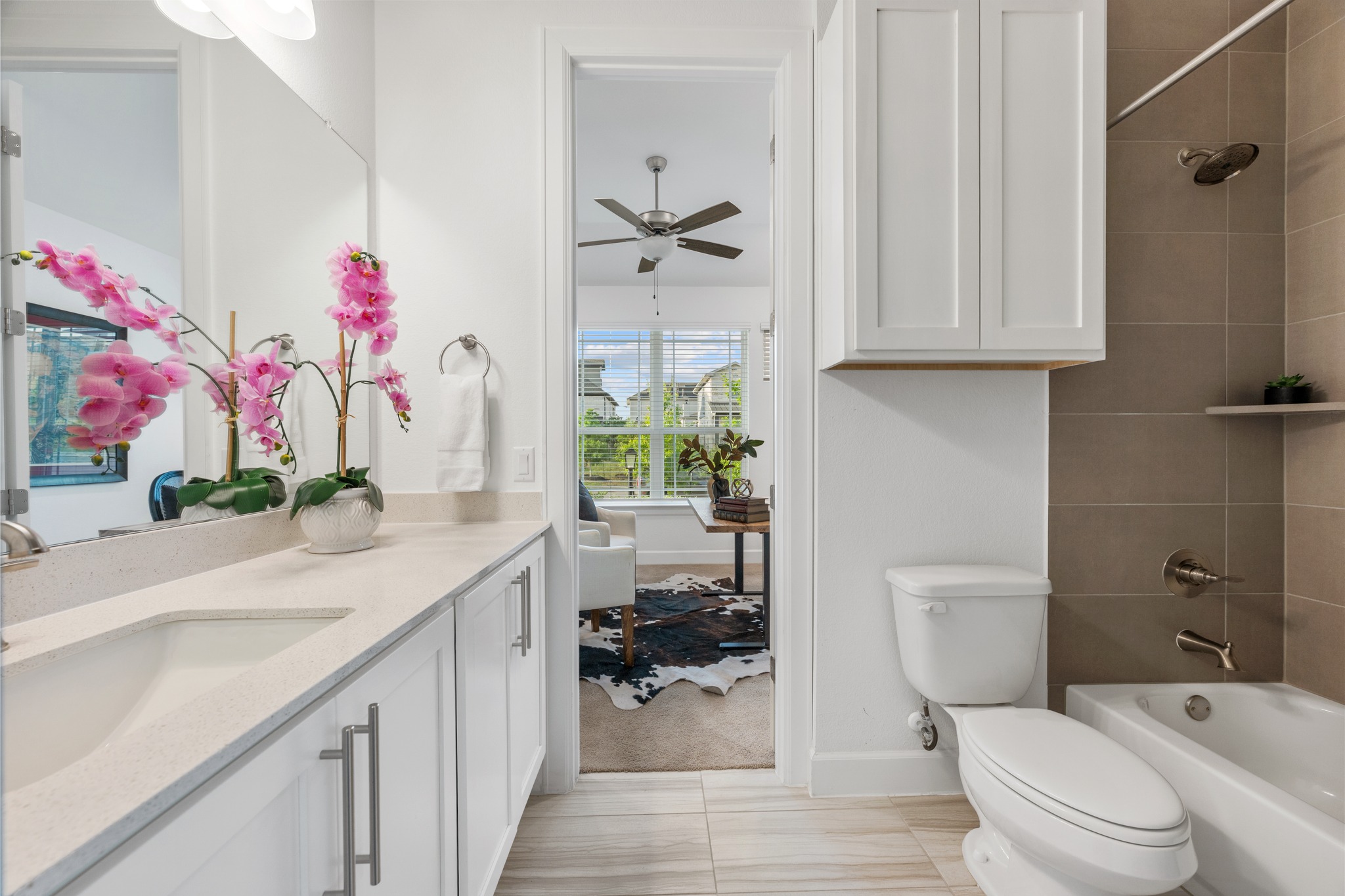 606 Bonfisk Bend Austin, TX 78738 - Photo 27 of 40 a bathroom with a granite countertop sink a toilet and a shower