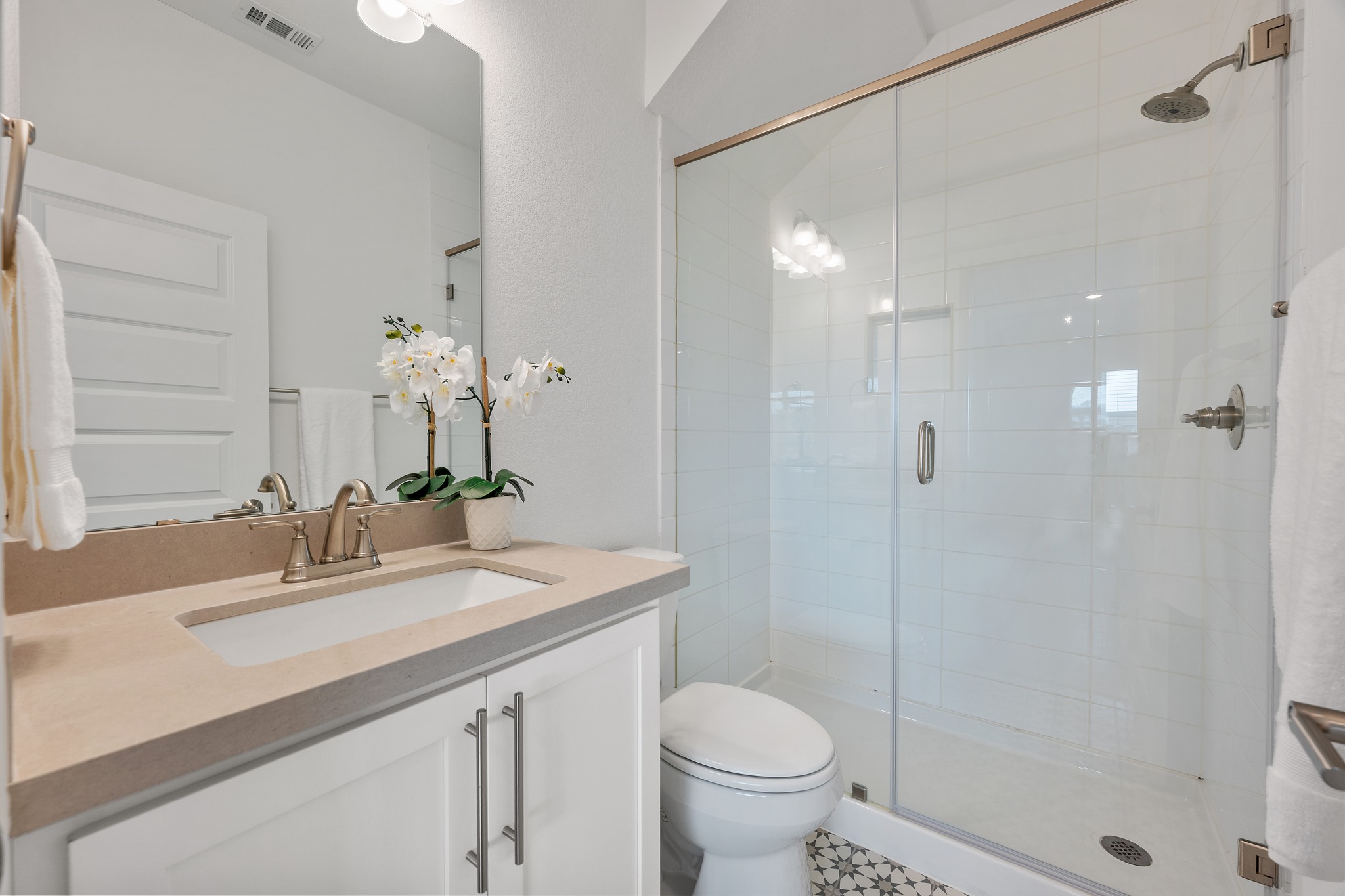 606 Bonfisk Bend Austin, TX 78738 - Photo 32 of 40 a bathroom with a sink toilet a mirror and shower