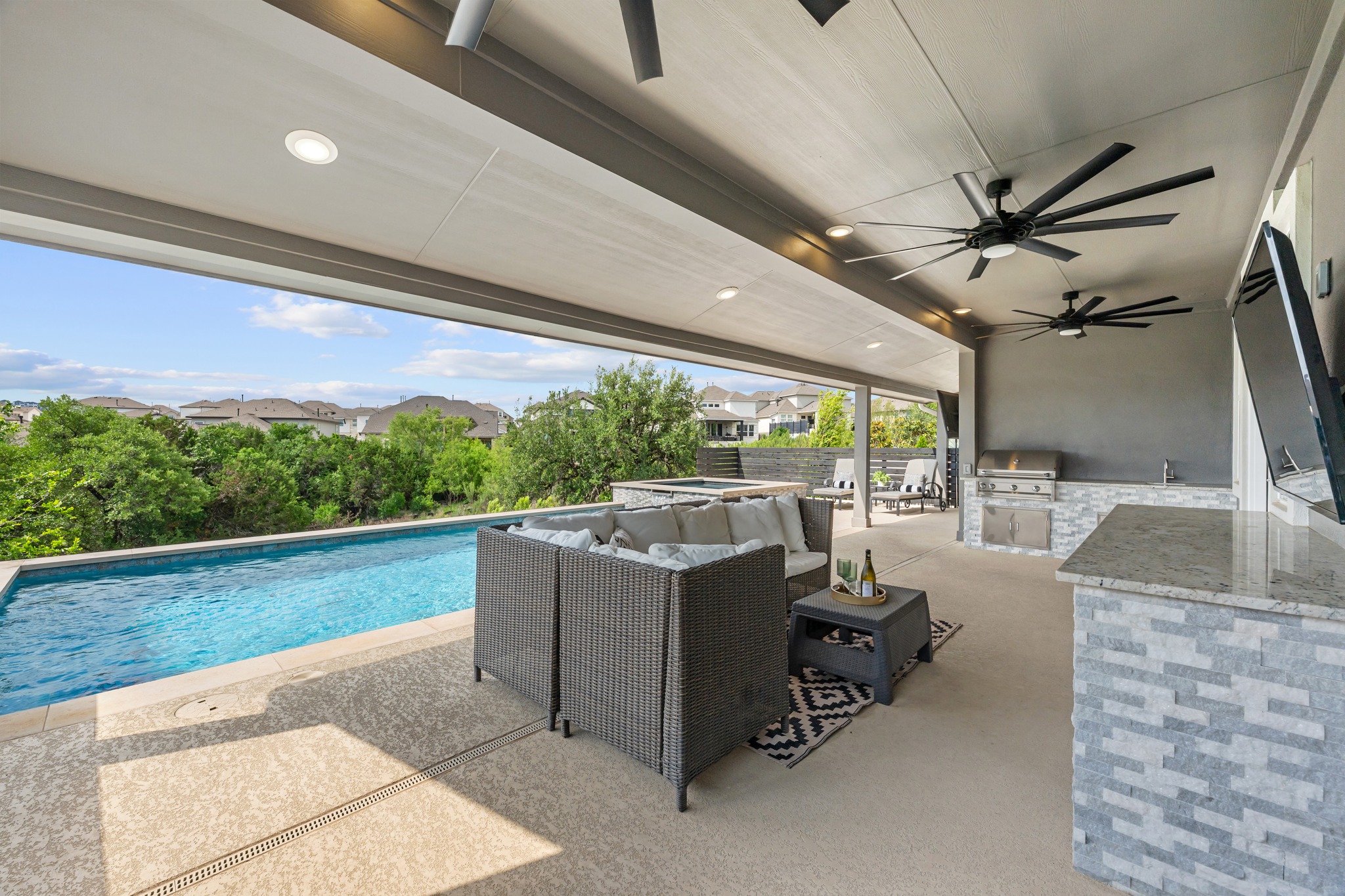 606 Bonfisk Bend Austin, TX 78738 - Photo 33 of 40 a view of a patio with a table and chairs